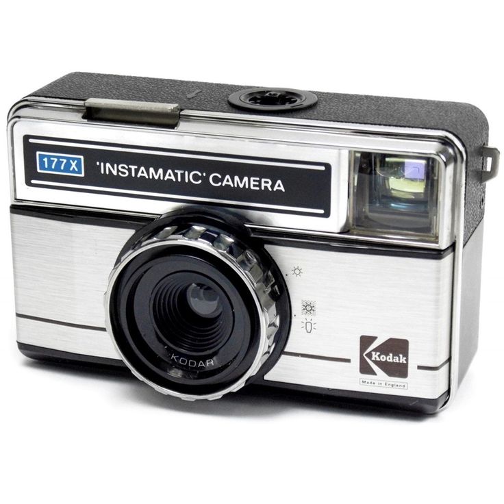 an old fashioned camera sitting on top of a white surface