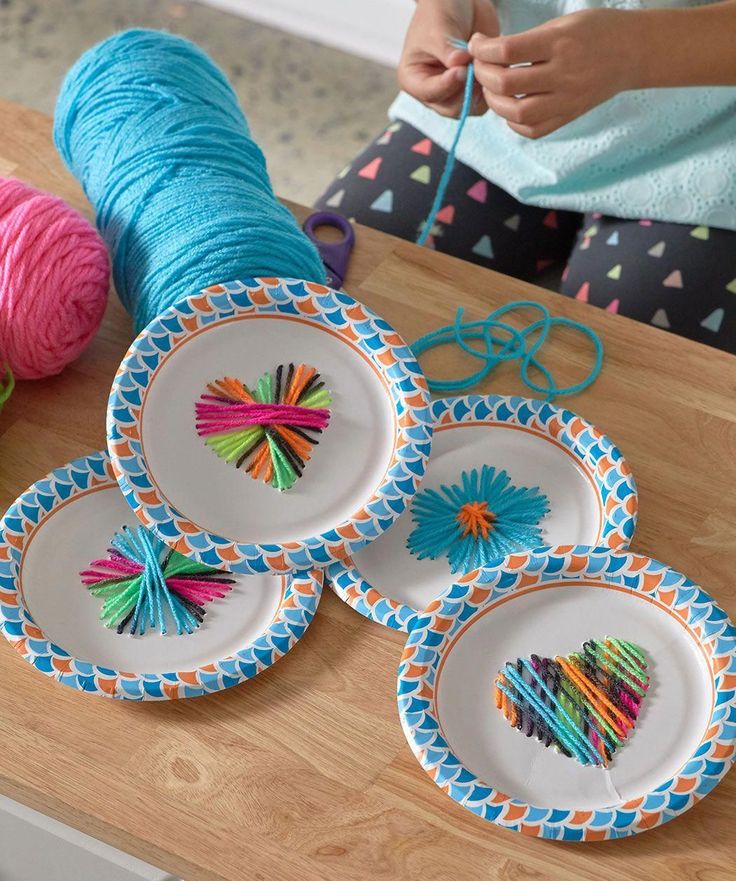 a table topped with plates and yarn on top of it