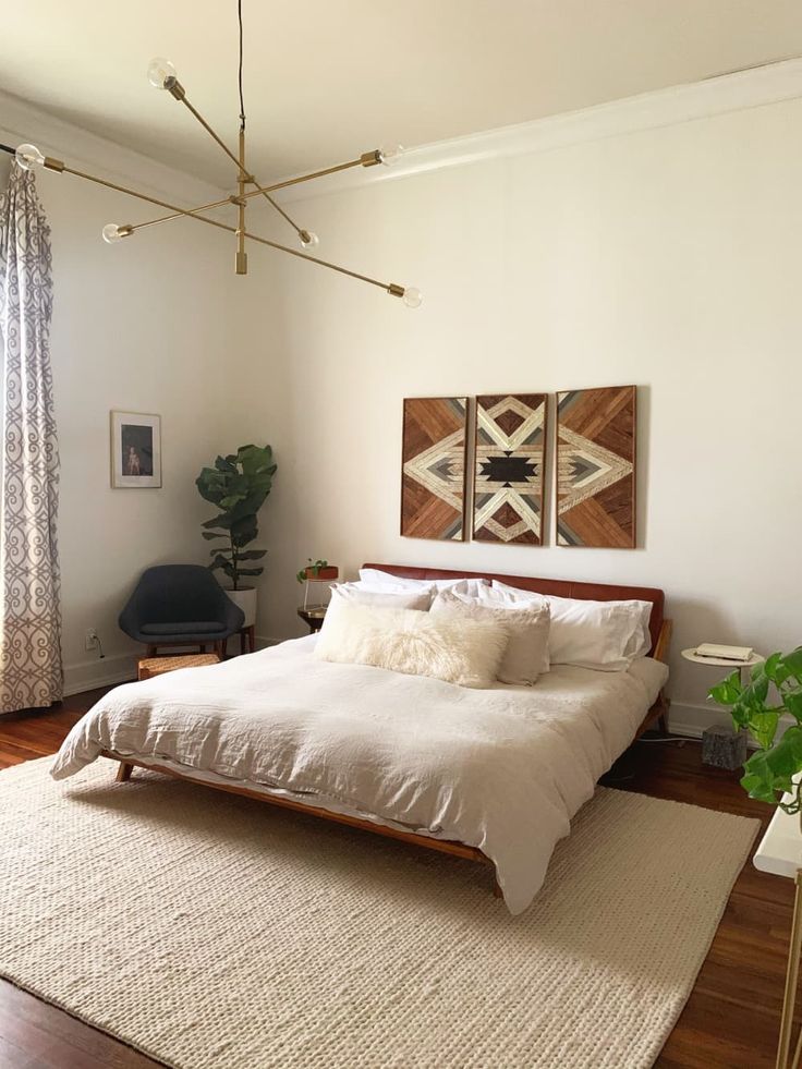 a bed sitting in a bedroom on top of a wooden floor next to a window