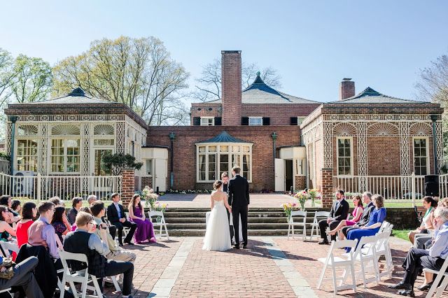 a bride and groom standing at the end of their wedding ceremony in front of an old brick building