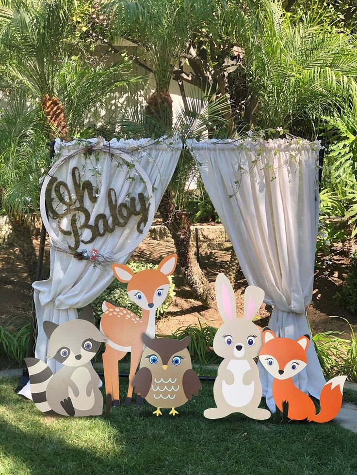 an outdoor baby shower is decorated with woodland animals