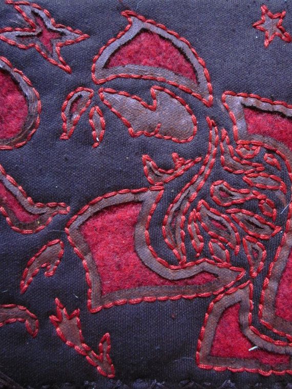 a close up of a piece of cloth with red stitching on it