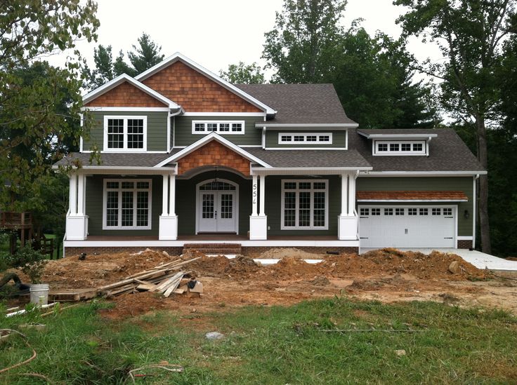 a house under construction with trees in the background