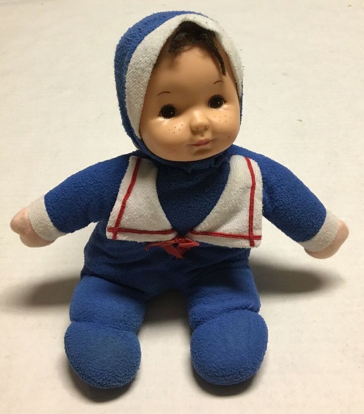 a blue and white baby doll with a hood on it's head sitting down