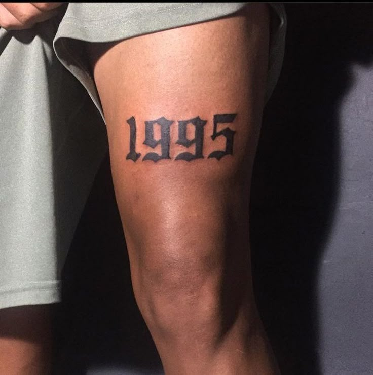 a person with a tattoo on their leg that says 9991 in black ink