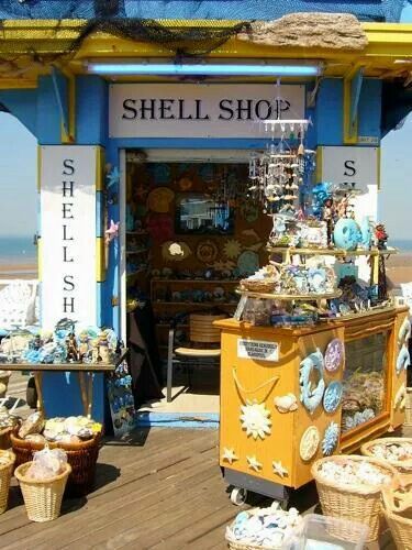 there is a small shop on the boardwalk by the beach with baskets and other items