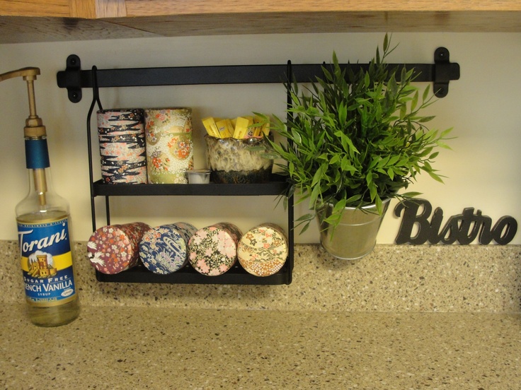 there is a bottle of booze next to some donuts and a potted plant