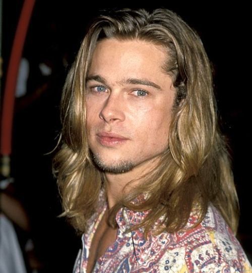 a young man with long hair and blue eyes