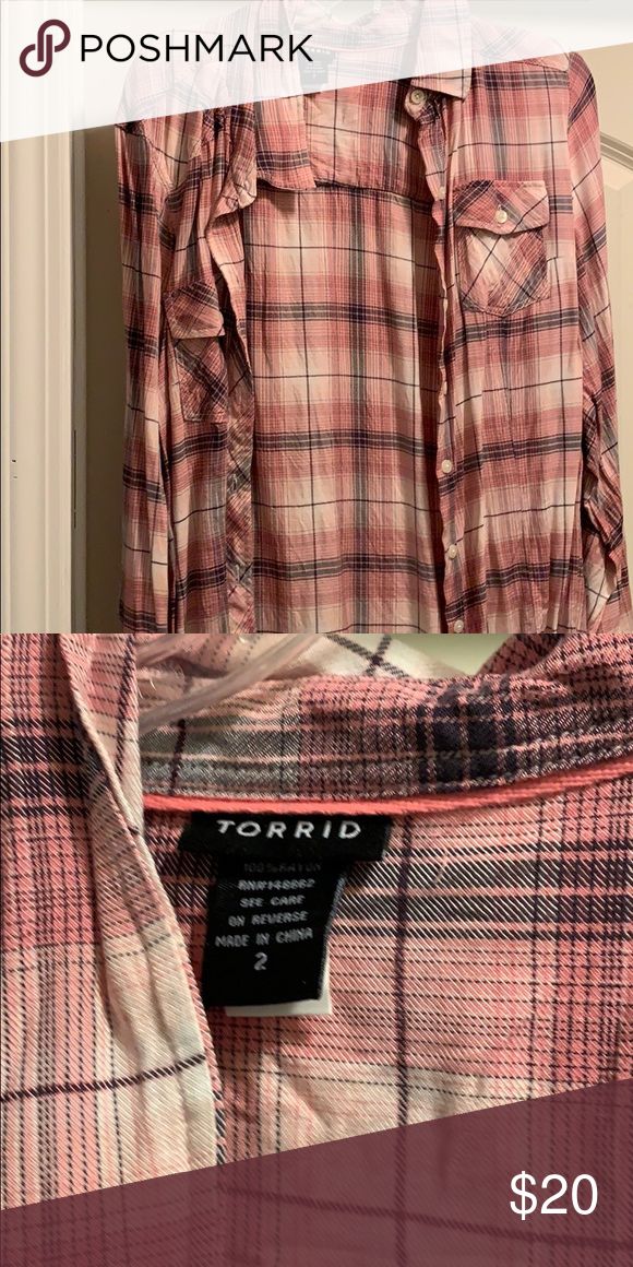 a pink and black plaid shirt is on display