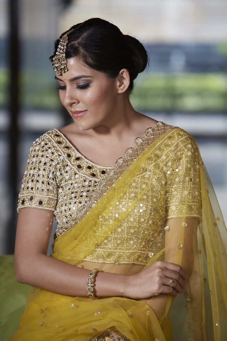 This crowd pleasing mustard net saree with mirror work highlight and scallop border detailing is paired with with our mirror and pearl work blouse. Designer Sheer Dupatta Blouse For Navratri, Designer Blouse With Sheer Dupatta For Navratri, Designer Wear Blouse With Sheer Dupatta For Navratri, Diwali Reception Blouse Piece With Mirror Work, Designer Sheer Dupatta Blouse For Diwali, Festive Yellow Pre-draped Saree With Mirror Work, Yellow Pre-draped Saree With Mirror Work For Wedding, Gold Bollywood Blouse With Sheer Dupatta, Bollywood Style Gold Blouse With Sheer Dupatta