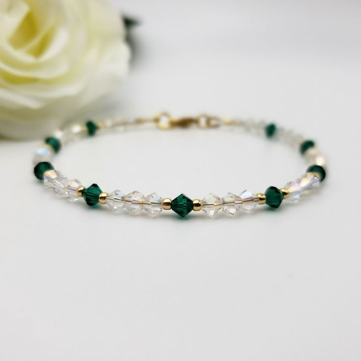 Looking for a special gift for someone with a May birthday? Consider this dainty birthstone bracelet featuring emerald green and Aurora Borealis shimmering clear crystals that sparkle brilliantly. May-born individuals are associated with the fabulous Emerald birthstone, and this delicate and sparkly bracelet is a lovely representation of that. It makes a special gift for anyone born in May under the Taurus or Gemini Zodiac signs. The bracelet has 4mm emerald green bicone-shaped premium crystals, May Birthstone Jewelry With Faceted Beads As A Gift, May Birthstone Spacer Beads Jewelry Gift, May Birthstone Bracelets With Faceted Beads As Gift, Faceted Beads Bracelet For May Birthstone Gift, Gift Jewelry With Spacer Beads For May Birthstone, Faceted Beads Bracelets As May Birthstone Gift, Gift Crystal Bracelet With Faceted Round Beads, Faceted Round Beads Crystal Bracelet Gift, Faceted Crystal Bead Bracelet Gift