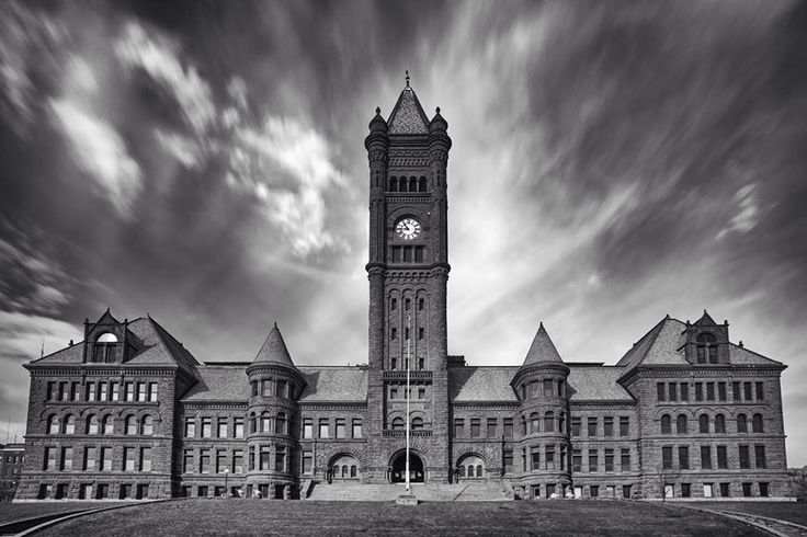 a black and white photo of a large building with a clock tower