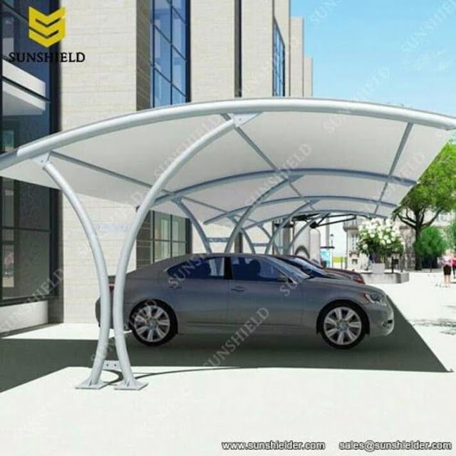 a car is parked under an awning on the street