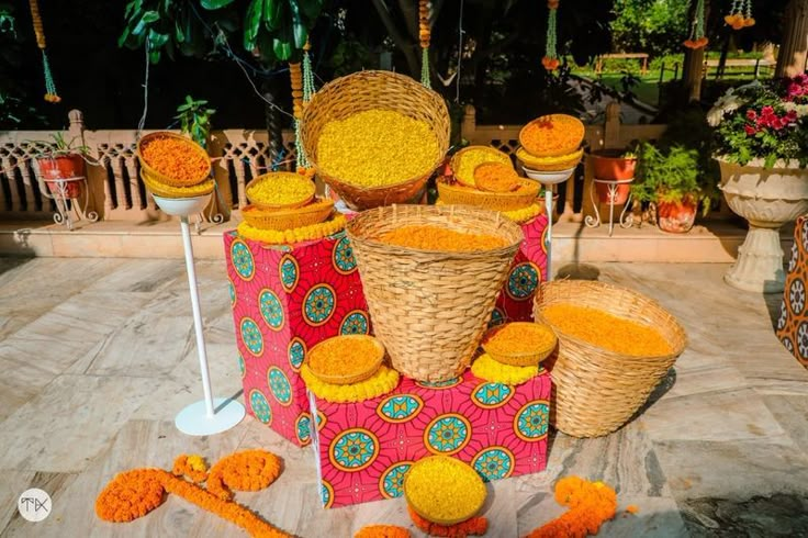 baskets and flowers are arranged on top of each other in the middle of an outdoor area