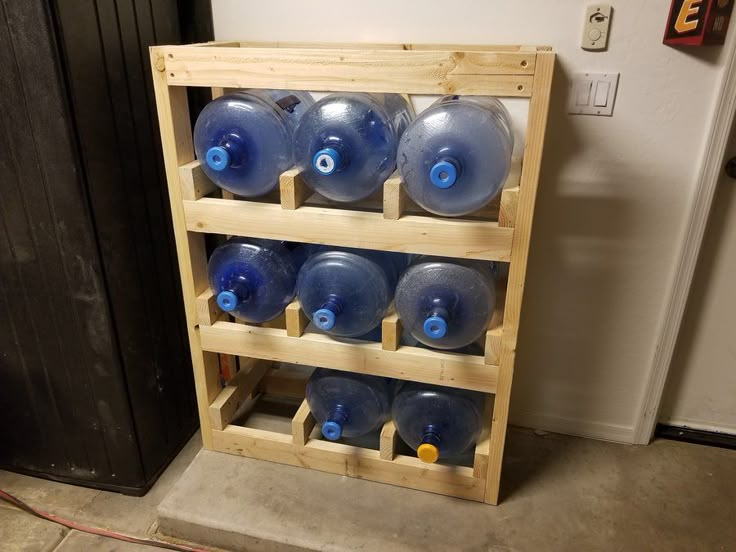 there are many blue water bottles on the shelf