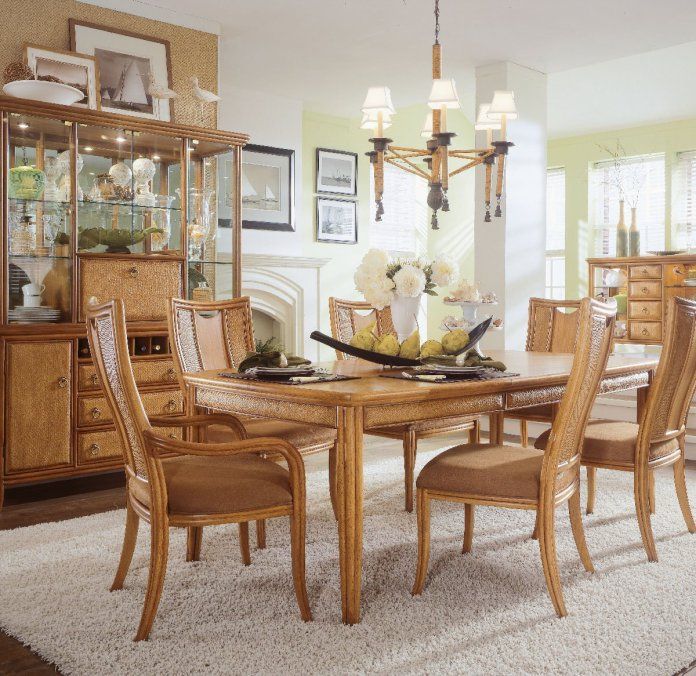 a dinning room table with chairs and a china cabinet in the middle of it