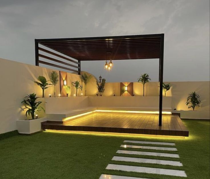 an outdoor area with grass, steps and lights