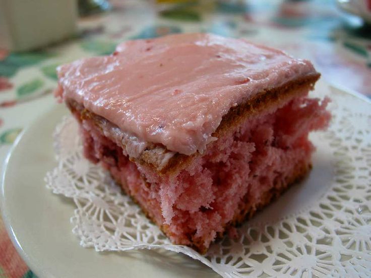 a close up of a piece of cake on a plate with a doily around it