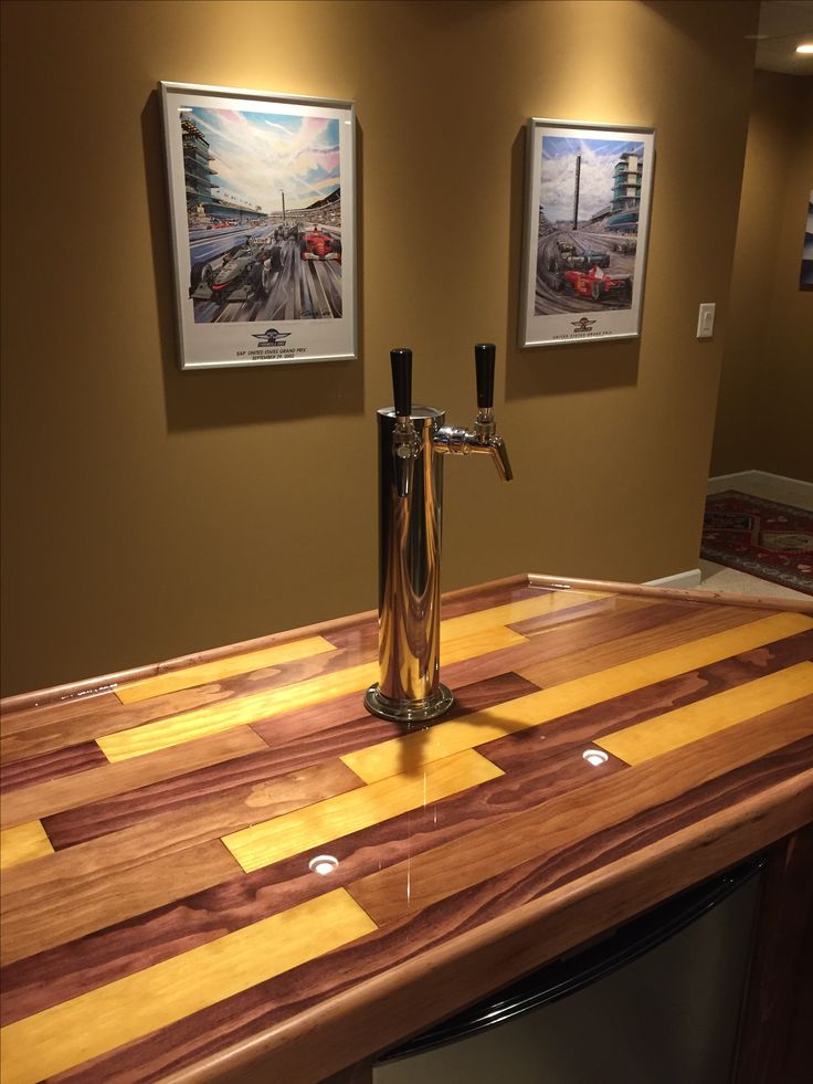 a kitchen counter with two pictures on the wall