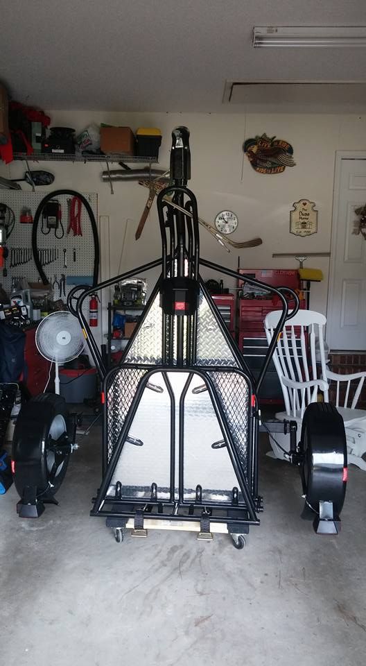 a garage filled with lots of different types of bikes and tools on the floor,