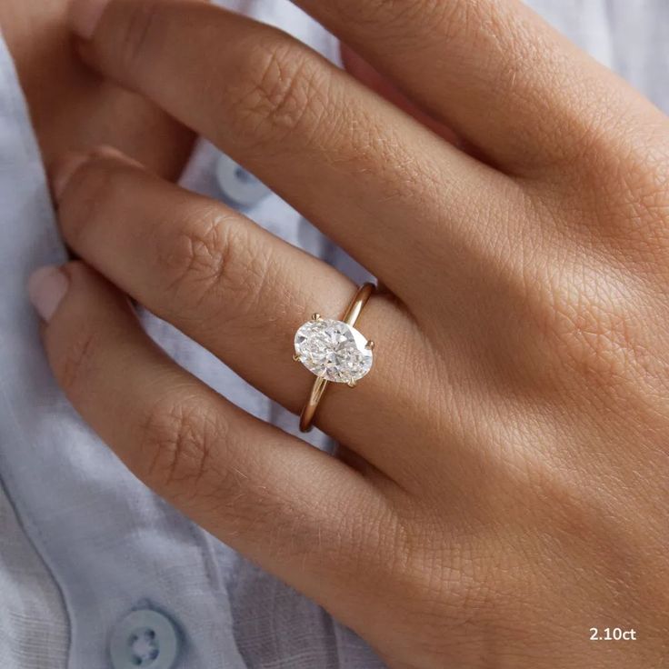 a woman's hand with a diamond ring on it