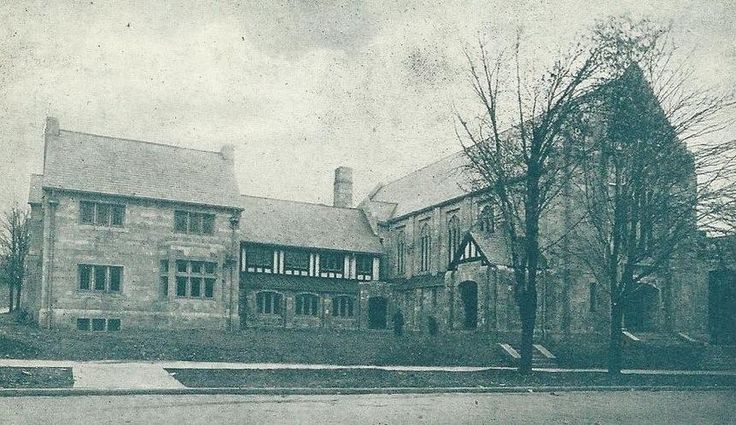 an old black and white photo of a large brick building with two storyed houses