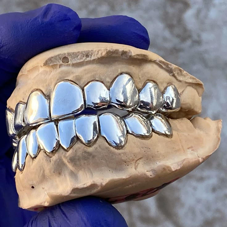 Check out this custom fitted 10/10 slugs we just did for a customer, real solid 925 sterling silver individual single cap perm look style, beautiful hand made work. Easy online ordering. Get slugged out! ☆925 Silver Perm Look Teeth Caps Grillz ☆ https://www.blingcartel.com/925-sterling-silver-perm-look-grillz.html Want to know how to make your custom grillz teeth mold? It's easy! Check out the mold video: https://youtu.be/fGZOVibuKis Teeth Grills, Silver Teeth, Bottom Teeth, Silver Grillz, Grillz Teeth, Dental Impressions, Custom Grillz, Gold Grillz, Loose Tooth