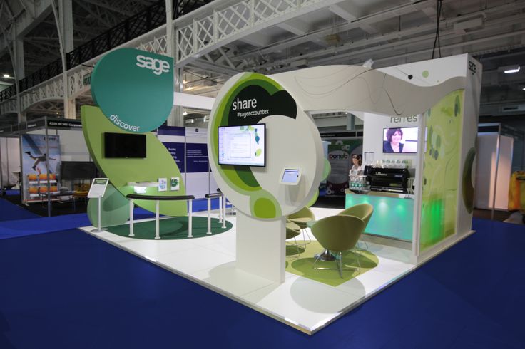 an exhibit booth with green and white furniture