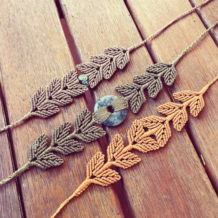 three pieces of crocheted thread with leaves on them