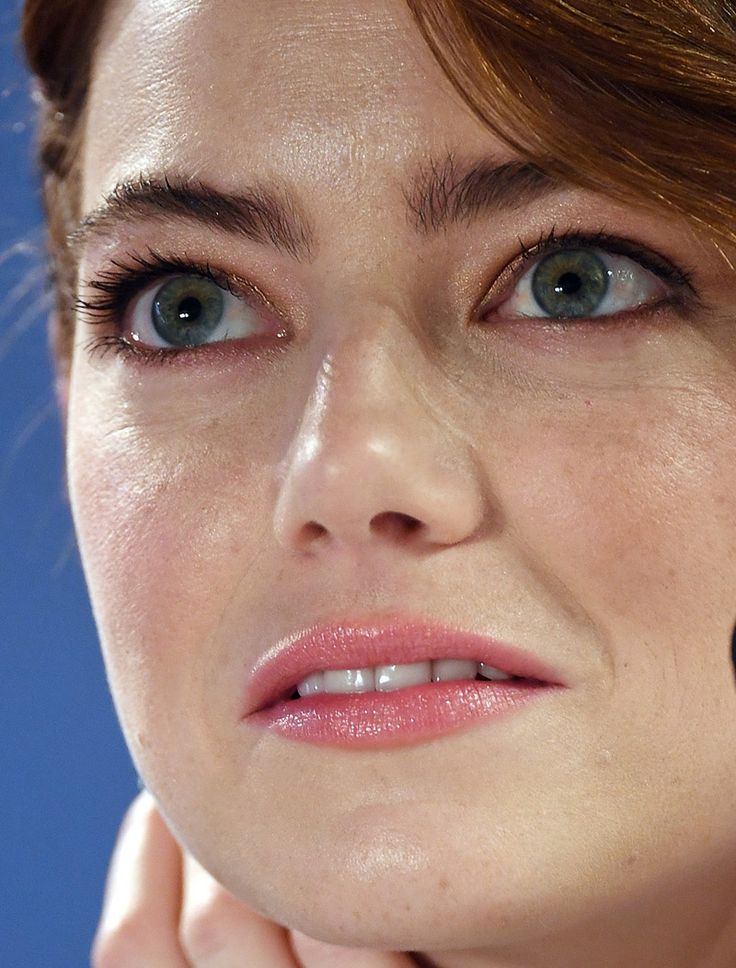 a close up of a woman with blue eyes