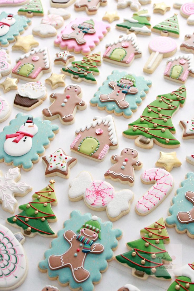 many decorated cookies are displayed on a table