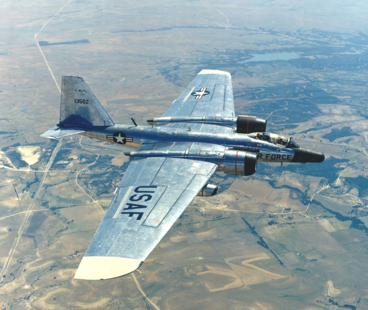 an air plane flying in the sky over land