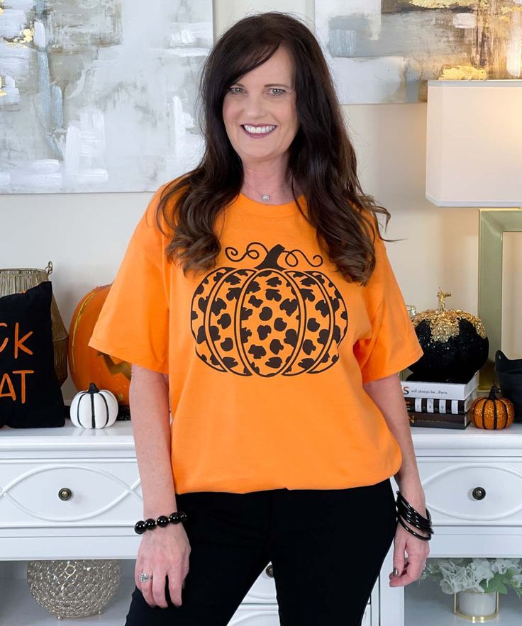 Embrace the fall season with a touch of wild style in the Black Leopard Pumpkin Graphic Shirt. This shirt features a striking black leopard print pumpkin, adding a trendy twist to your autumn wardrobe. Perfect for pumpkin season, it combines the classic pumpkin design with a fierce leopard pattern. Available in sizes YXS-5XL and your choice of shirt color, this graphic shirt is ideal for showcasing your love for fall with a fashionable edge. Trendy Orange Fall Tops, Orange Cotton Top For Fall, Orange Cotton Tops For Fall, Orange Relaxed Fit Tops For Fall, Leopard Print Pumpkin, Pumpkin Graphic, Leopard Pumpkin, Autumn Wardrobe, Pumpkin Season