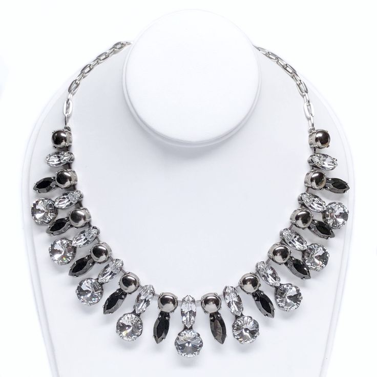 Indulge in the ultimate in luxury with the Selene Necklace. Vintage rhinestones and modern crystals come together seamlessly in this opulent piece. The high-end quality and versatility of this necklace make it the perfect choice for any occasion, from a formal gala to a casual dinner with friends. The addition of silver studs creates a balance that highlights the beauty of each element, making this necklace an assemblage masterpiece. DETAILS ✨𝗥𝗘𝗔𝗗𝗬 𝗧𝗢 𝗦𝗛𝗜𝗣✨ Packaged in a hardwood jewe Elegant Diamond Necklace With Jewels For Formal Occasions, Opulent Cubic Zirconia Jewelry For Parties, Elegant Diamond Necklace For Formal Occasions, Opulent Cubic Zirconia Party Jewelry, Opulent Evening Jewelry With Diamond Accents, Elegant Diamond White Necklaces With Jewels, Dazzling Metal Necklaces For Formal Events, Elegant Metal Necklace With Bling, Elegant Crystal Rhinestone Necklace For Formal Occasions