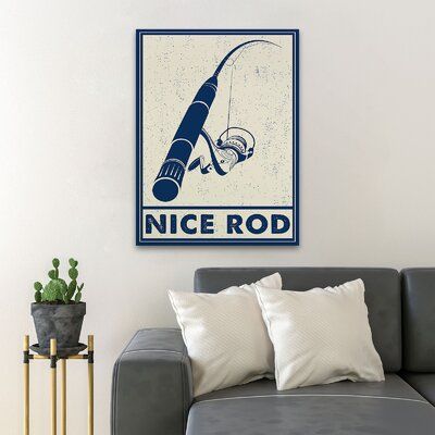 a living room with a gray couch and a blue sign on the wall that says nice rod