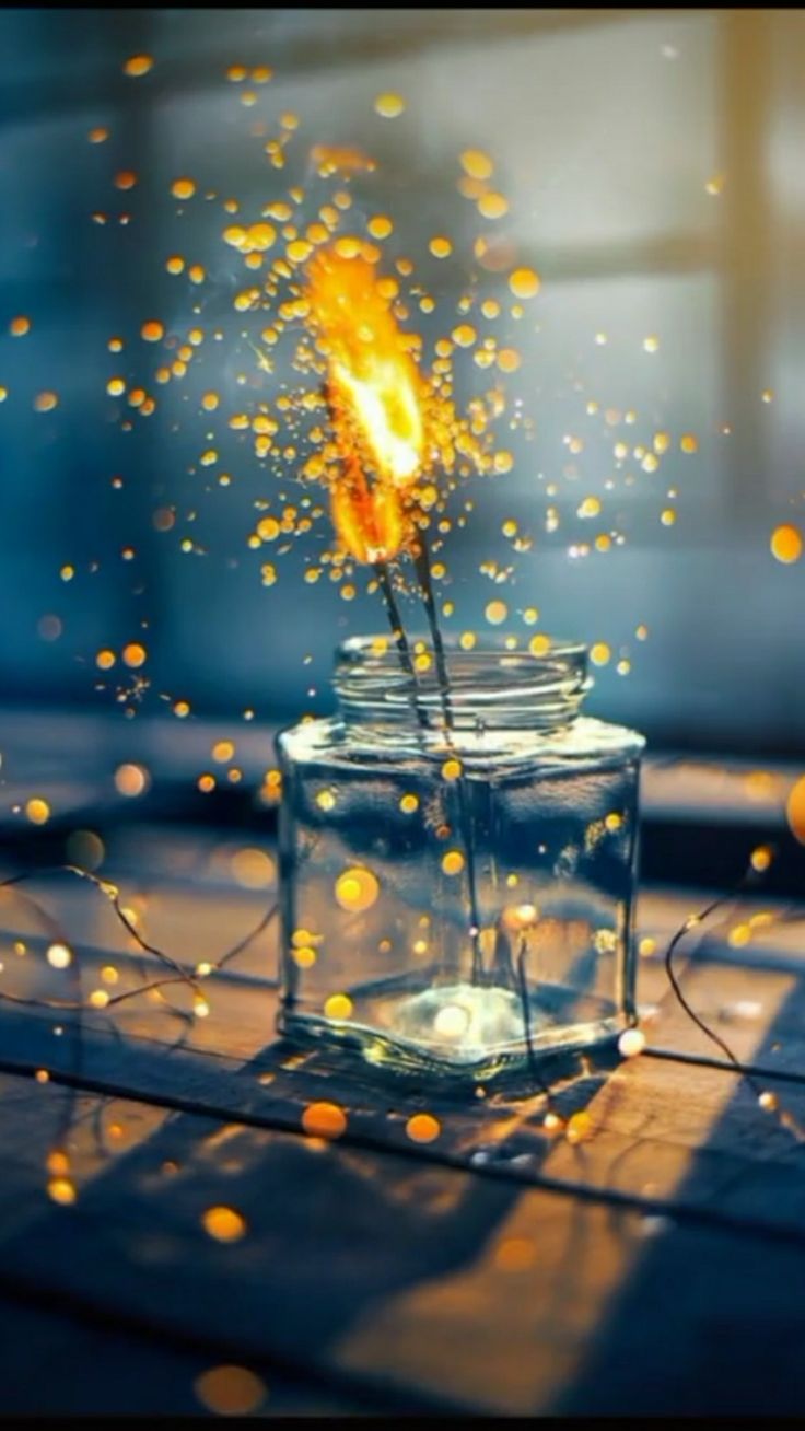 a glass jar filled with water and fire