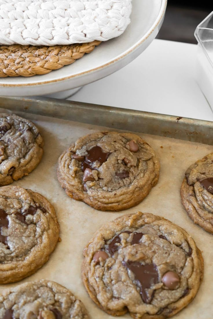 chocolate chip cookies sitting on top of a cookie sheet