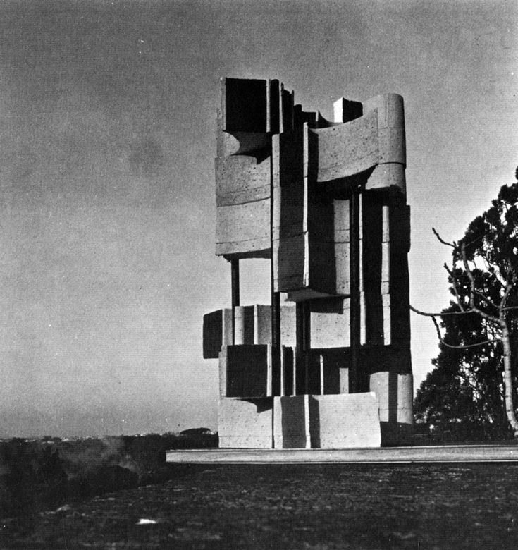 an old black and white photo of a building with many square blocks on it's side