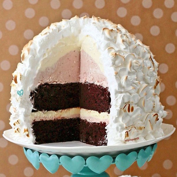 there is a cake with white frosting on the top and one slice missing from it