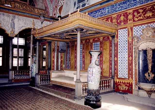 an ornately decorated room with blue and red walls