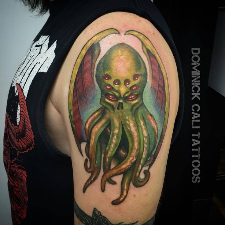 an octopus tattoo on the arm and shoulder