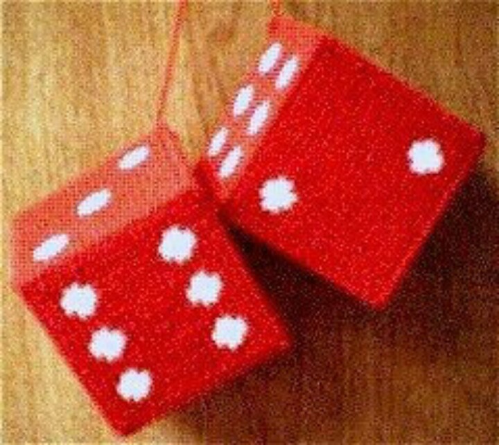 two red dices sitting on top of a wooden table