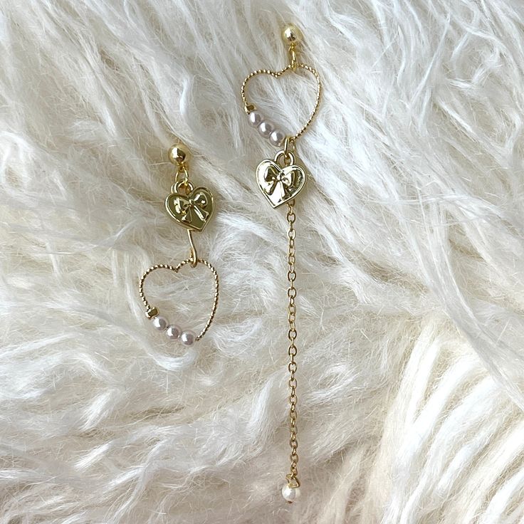 Super cute and romantic mismatch gold heart hoop dangling earrings earrings with pearl and gold ribbon bow tie signet in detail. Delicate handwork in 14k gold plate sterling silver, good for sensitive skin and not tarnishable. Dainty sparkly asymmetrical chicness, perfect for everyday, also a unique choice as bridal bridesmaid wedding earrings. ♥ All of our jewelry are carefully handmade with delicate and exquisite details, all designed and made in Manhattan, New York. 💎 Features: ♥ Made to Order ♥ Material: 14K Gold plated sterling silver ♥ Side Stone: pearl ♥ Push back Closure 💎 Details: ♥ Approximate Measurements: - Length: 3.5", 1.25" each - Width: 0.5" ♥ Lightweight, easy to wear ♥ Nickel/Lead Free, Hypoallergenic 💎 Packing & Shipping: ♥ All our jewelry will be shipped with beautif Elegant Gold Plated Heart Earrings As Gift, Heart Shaped Pearl Earrings As Gift, Dangle Pearl Earrings For Valentine's Day, Valentine's Day Dangle Pearl Earrings For Pierced Ears, Elegant Heart-shaped Dangle Earrings Gift, Elegant Single Heart Earring For Valentine's Day, Valentine's Day Dangle Pearl Earrings, Valentine's Day Single Dangle Earring Jewelry, Valentine's Day Dainty Gold Plated Earrings