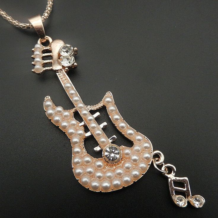 327 Nwot Pearl And Crystal Guitar Pendant Necklace A Cute Music Note Hangs From The End Of The Guitar. Chain - 27" L With 2" Extension Pendant - 3.5" L (Includes Bale And Note) X 1" W All Measurements Are Approx. Comes Boxed.. Guitar Pendant, Music Note Necklace, Cute Music, Jewelry Pearl, Guitar Music, Music Note, Music Notes, Pearl Jewelry, Womens Jewelry Necklace