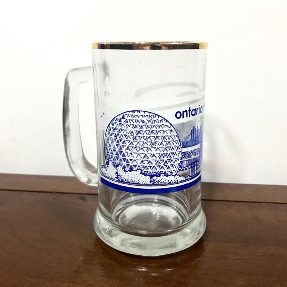 a glass mug sitting on top of a wooden table