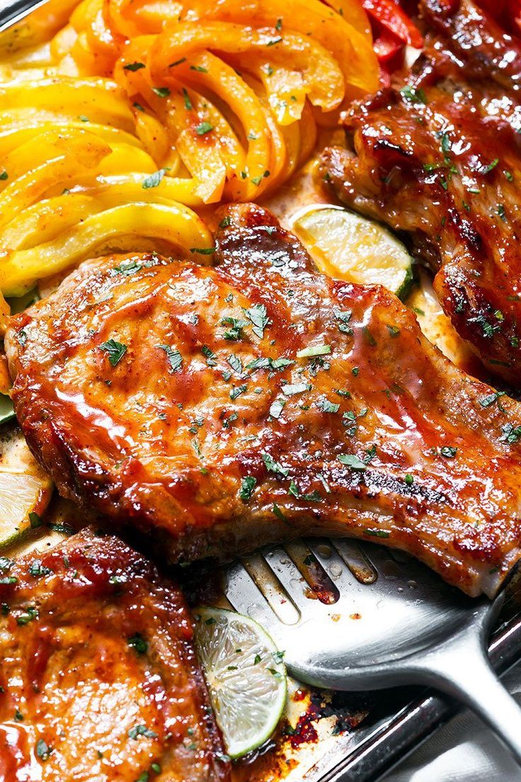 grilled meat and vegetables on a tray with fork