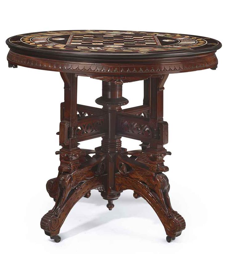 an ornately carved wooden table with intricate carvings on the top and bottom, against a white background