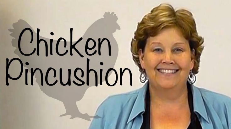 a woman standing in front of a sign that says chicken pincusion on it