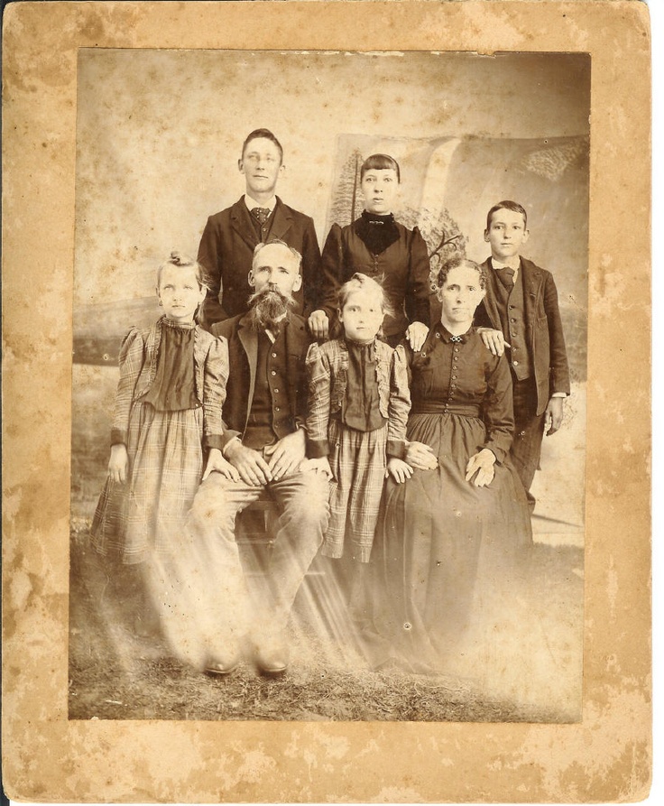 an old photo of a family posing for a picture