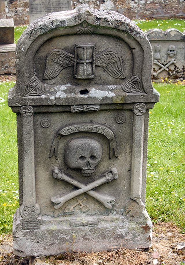 a grave with a skull and crossbones on it